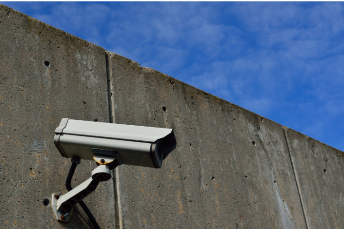 Security camera mounted on concrete wall