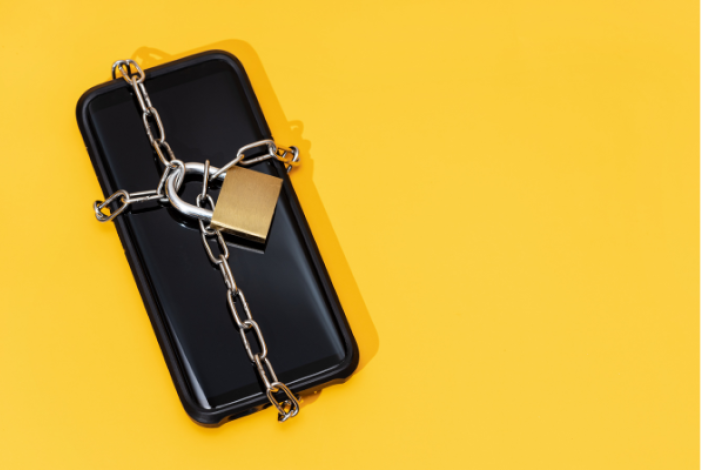 cell phone wrapped in chain locked with padlock