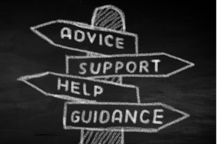 sign post written in chalk on a black board. the signs read advice, support, help, guidance. each sign is pointing in a different direction.